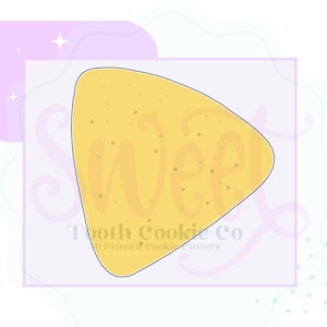 May include: A yellow cookie cutter shaped like a triangle with rounded edges. The cutter is designed to create a cookie in the shape of a nacho chip.