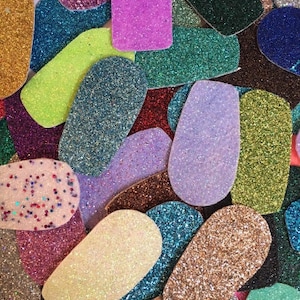 May include: Assortment of colourful glitter fabric scraps in various shapes and sizes. The fabric scraps are perfect for crafting projects, such as hair bows, earrings, and keychains.