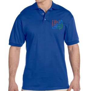 May include: A royal blue polo shirt with a short sleeve and a button-down collar. The shirt has a small embroidered rectangle on the left chest with the text "YOUR DESIGN HERE" in colorful letters.