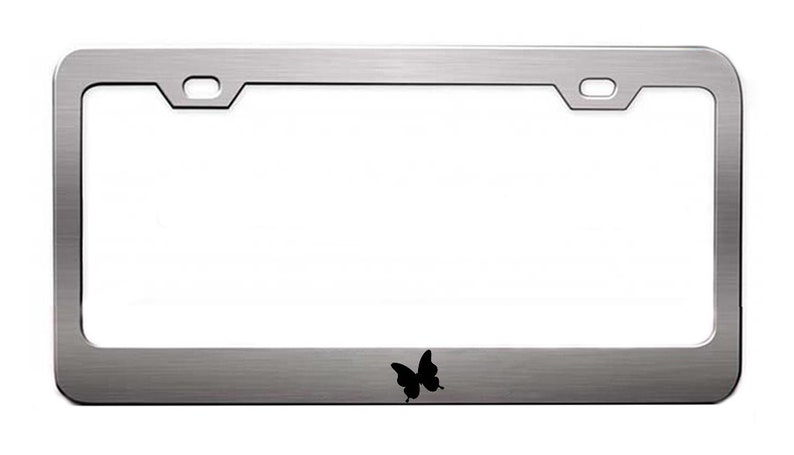 May include: A silver metal license plate frame with a black butterfly silhouette in the lower center.