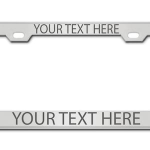 May include: Silver metal license plate frame with the text "YOUR TEXT HERE" on the top and bottom.