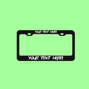 May include: Black metal license plate frame with white text that says "YOUR TEXT HERE!" on the top and bottom.