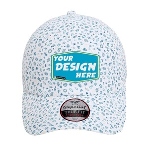 Op de afbeelding: Witte baseballpet met een blauw-wit patroon van verschillende iconen. De pet heeft een blauw patch met de tekst "YOUR DESIGN HERE" en een zwart en rood label met de tekst "Imperial True Fit UPF 50+"