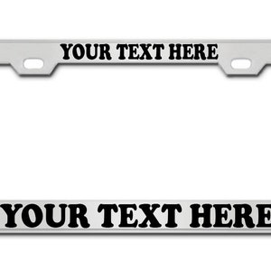 May include: Silver metal license plate frame with the text "YOUR TEXT HERE" printed in black on the top and bottom.