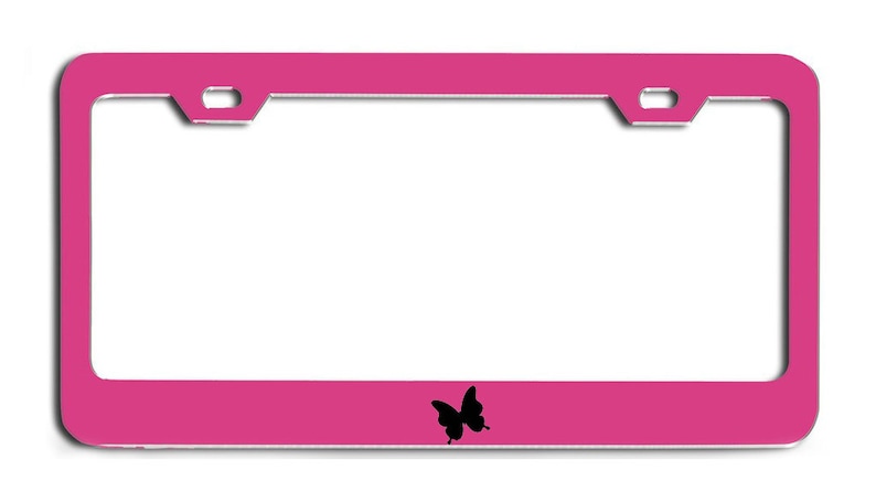 May include: A pink metal license plate frame with a black butterfly silhouette in the center.