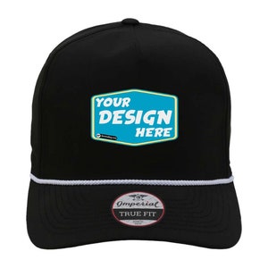 May include: Black trucker hat with a white rope trim and a blue and yellow patch that says "YOUR DESIGN HERE". The hat also has a black label that says "Imperial True Fit" on the bottom.