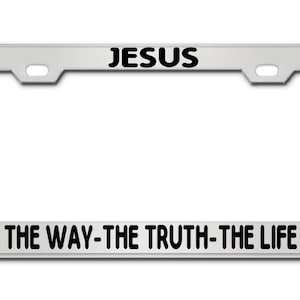 May include: Silver license plate frame with black text that reads "JESUS THE WAY-THE TRUTH-THE LIFE" with a cross on either side.