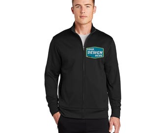 Könnte beinhalten: Eine schwarze Reißverschlussjacke mit einem blauen und grünen rechteckigen Patch, auf dem "YOUR DESIGN HERE" steht.
