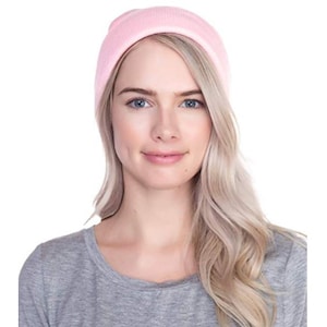 May include: A pink knit beanie hat. The hat is made of soft, warm material and is perfect for keeping your head and ears warm in the winter.