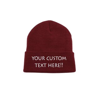 May include: A maroon beanie with white text that reads "YOUR CUSTOM TEXT HERE!!"