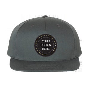 May include: A dark gray, flat-brimmed baseball cap with a black circle on the front that says "Customized by General Tag" in yellow text and "Your Design Here" in white text.