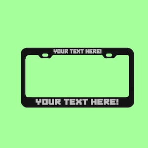 May include: Black metal license plate frame with the text "YOUR TEXT HERE!" on the top and bottom.