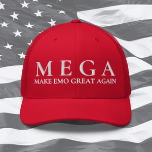 May include: Red baseball cap with a white mesh back. The front of the cap has white embroidered text that reads "MEGA MAKE EMO GREAT AGAIN".