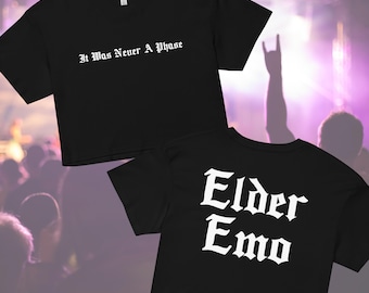 May include: Two black crop tops with white text. The top on the left says "It Was Never A Phase". The top on the right says "Elder Emo".