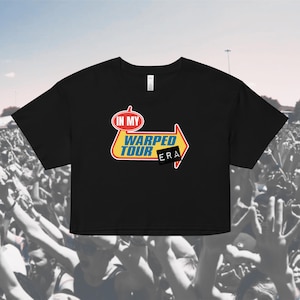 May include: Black cropped t-shirt with a yellow, blue, and red graphic of a sign that says "In My Warped Tour Era".