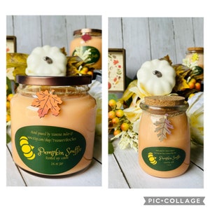 May include: Two glass jars of pumpkin souffle scented soy candles. The jars are 16 ounces and have a brown lid and a cork lid. The candles are a light orange color and have a fall leaf design on the front. The text on the jars reads "Pumpkin Souffle" and "Scented soy candle".