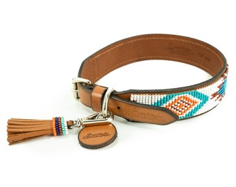 May include: A brown leather dog collar with a turquoise, white, and orange beaded pattern. The collar has a metal clasp and a brown leather tassel.