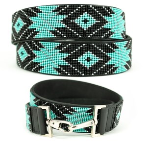 May include: A turquoise and black beaded belt with a geometric pattern. The belt is made of leather and has a silver buckle.