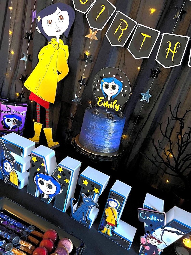 May include: A birthday party table setting with a blue and white cake decorated with a character from the movie Coraline. The cake is on a black cake stand. There are white letters spelling out "EMILY" with black and blue accents and characters from the movie Coraline on each letter. There is a black and white banner that says "BIRTHDAY" and a black and white bag with the words "Happy Birthday" and a character from the movie Coraline on it.