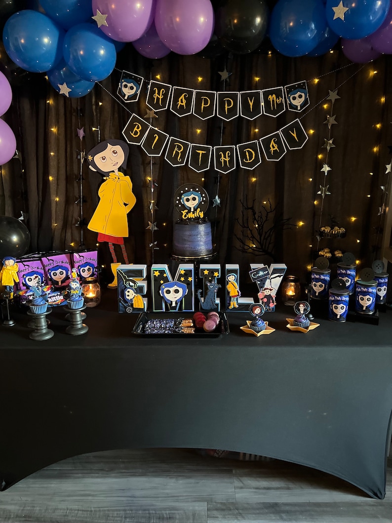 May include: A birthday party table decorated with a black and white "Happy Birthday" banner, black and purple balloons, and a black tablecloth. The table is decorated with a cake, cupcakes, and other treats. The theme of the party is "Coraline", a children's book and movie. The cake is decorated with a picture of Coraline, and the cupcakes are decorated with pictures of Coraline and other characters from the book.