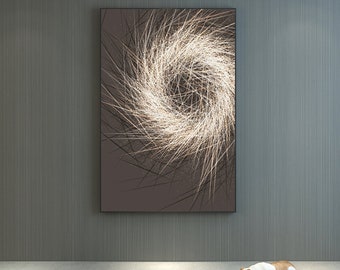 May include: A framed abstract art print with a swirling pattern of white lines on a brown background. A white and brown bulldog figurine is lying on the floor next to a magazine.