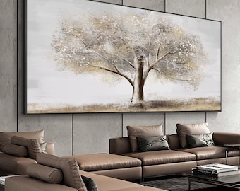 May include: A large abstract painting of a tree with white and brown branches against a white background. The painting is framed in black and hangs on a gray wall.