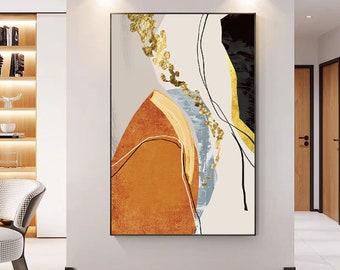 May include: Abstract art print featuring a composition of geometric shapes in shades of orange, gold, black, and gray. The artwork includes gold leaf accents and thin black lines against a neutral background, framed in black.