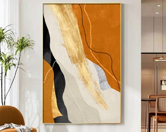 May include: Abstract art print with gold, orange, black, and white paint strokes. The print is framed in a gold frame.