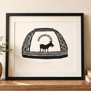May include: A framed black and white print featuring a stylized illustration of an ibex with long curved horns centered inside a dome-shaped vessel design with geometric patterns and horizontal lines at the base, set against a cream background.