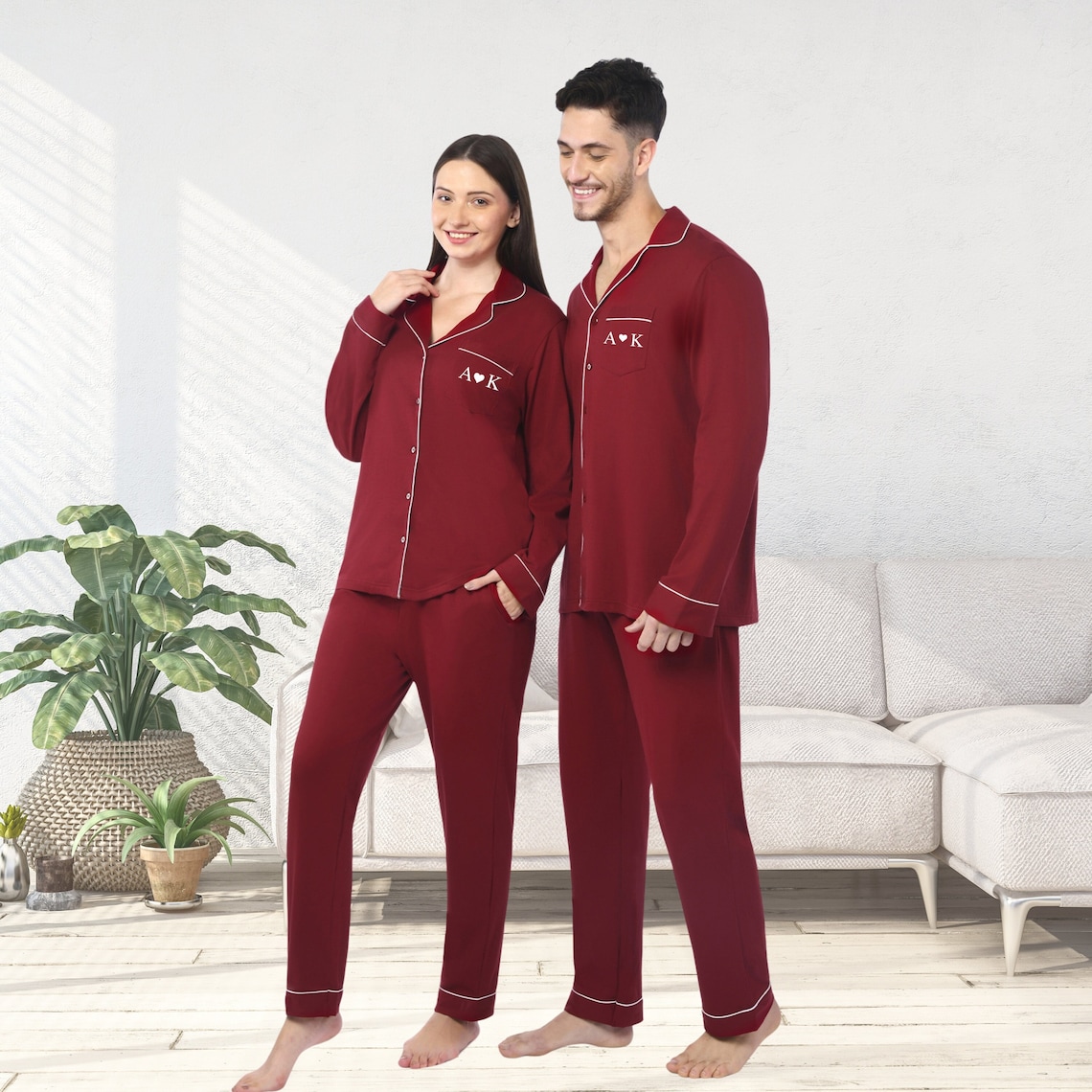 May include: Two matching sets of maroon pajamas with white piping and white embroidery. The embroidery says 'A♥K'.