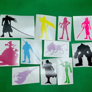 May include: A set of ten vinyl stickers featuring various characters from the Final Fantasy video game series. The stickers are printed on white vinyl and feature black, white, pink, yellow, green, and purple silhouettes of characters.