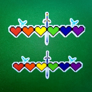 May include: Two rows of rainbow-colored hearts with a sword in the middle. Each heart has a pixelated design. The hearts are surrounded by small blue fairy wings.