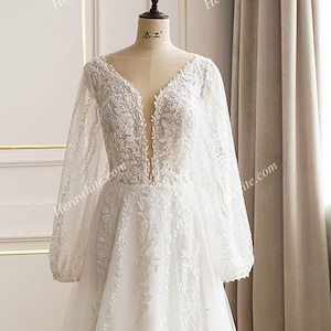 Trendy, Floral Plunge neck, Long Sleeves, Lace A line Wedding Dress. Plus size Available 20 us to 28 us.