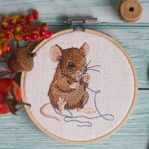 Embroidery file mouse with needle and thread