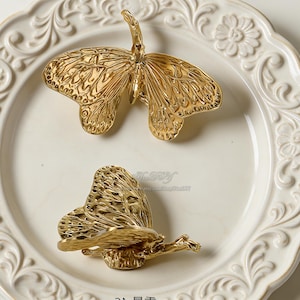 May include: A trio of ceramic mugs with a speckled, matte finish in cream, light grey, and dark grey. Each mug features a simple, minimalist design, ideal for tea or coffee.