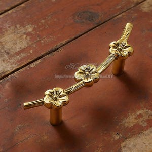 May include: A white ceramic mug with a black handle and the text "But First, Coffee" in a black, bold font. The mug is on a white surface. The mug appears to be 12 ounces.