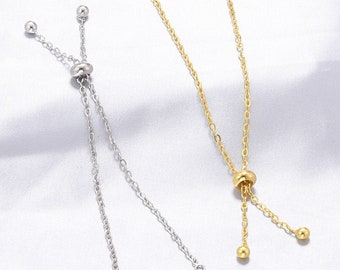 May include: Two adjustable bracelets with a sliding bead. One bracelet is silver and the other is gold.