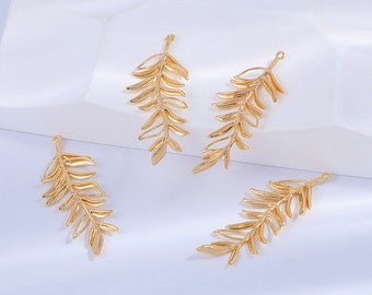 May include: Four gold-colored metal leaf charms with a delicate, detailed design. The charms are perfect for adding a touch of nature to jewelry projects.