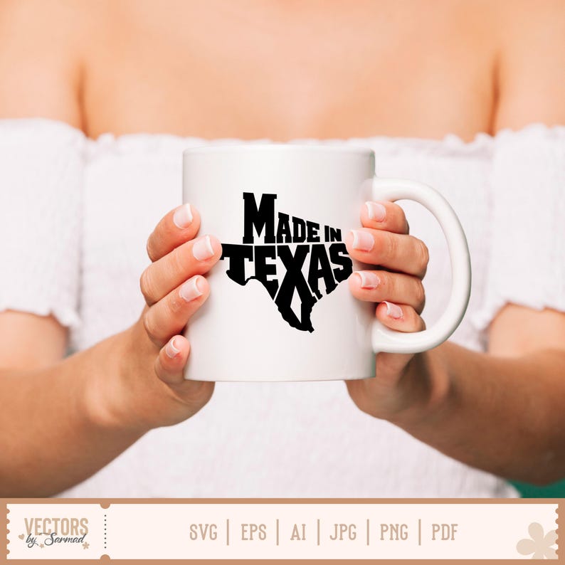 May include: White ceramic mug with a black graphic of the state of Texas and the words "MADE IN TEXAS". The mug has a curved handle and is held by a person.