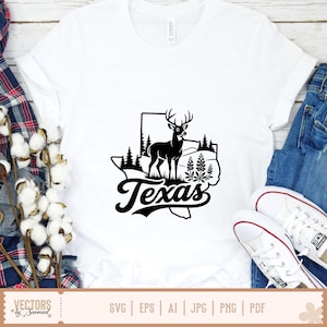 May include: White t-shirt featuring a black graphic of the state of Texas with a deer, trees, and the word "Texas" in a stylized font. The shirt is paired with blue jeans and white sneakers.