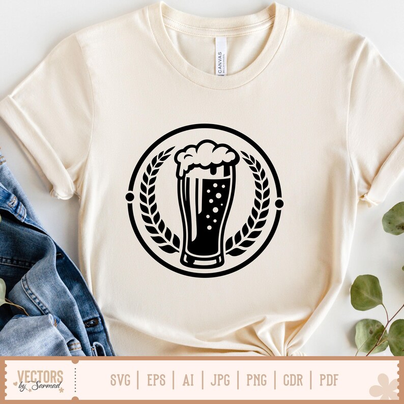 May include: Cream-colored t-shirt featuring a black graphic of a beer glass with foam, inside a circular wreath. The shirt has short sleeves and a crew neck. The bottom of the shirt shows the text "SVG | EPS | AI | JPG | PNG | GDR | PDF".