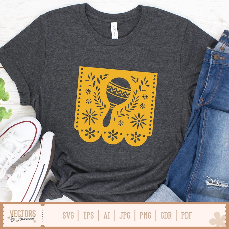 May include: Charcoal grey t-shirt with a yellow maraca design in a floral frame. The maraca has a zigzag pattern. The shirt is styled with blue jeans and white trainers. The text "VECTORS by Sarmad" is at the bottom of the image.