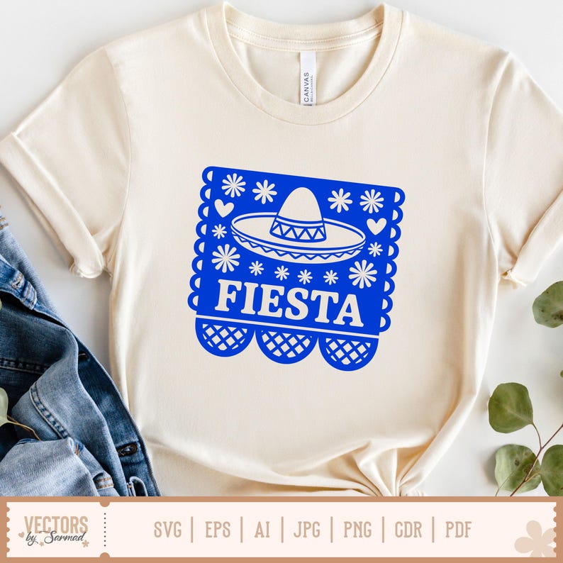 May include: A cream-coloured t-shirt with a blue graphic. The graphic features a sombrero and the word "FIESTA", along with floral and heart motifs. The shirt is made of a soft material, suitable for casual wear.