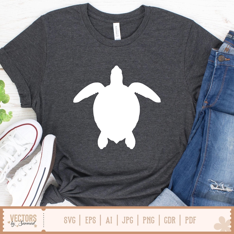 May include: Dark gray t-shirt featuring a large white sea turtle silhouette. The shirt is paired with blue jeans and white sneakers. The bottom of the image includes the text "VECTORS by Sarmad" and file type options.