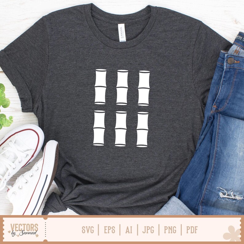 May include: Dark gray t-shirt featuring a white bamboo graphic. The design consists of six bamboo stalks arranged in a grid pattern. The shirt is paired with blue jeans and white sneakers.