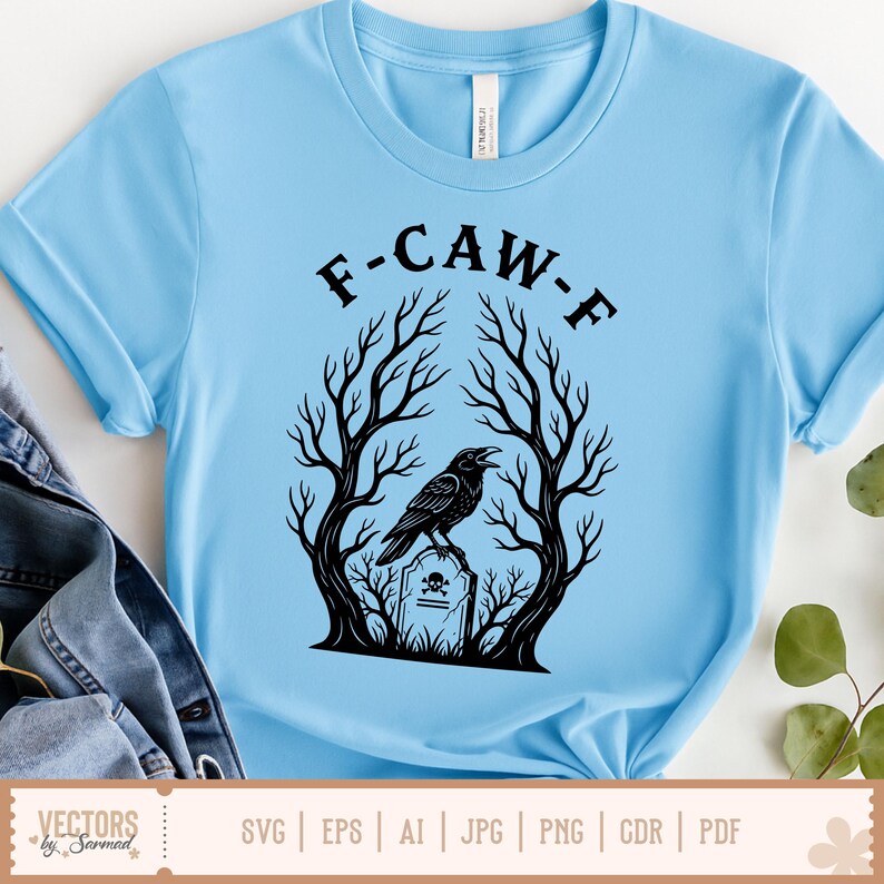 May include: Light blue t-shirt with a black graphic featuring a raven perched on a tombstone, framed by bare trees. The text "F-CAW-F" is arched above the raven. The bottom of the shirt has the text "VECTORS by Sarmad" and file type icons.