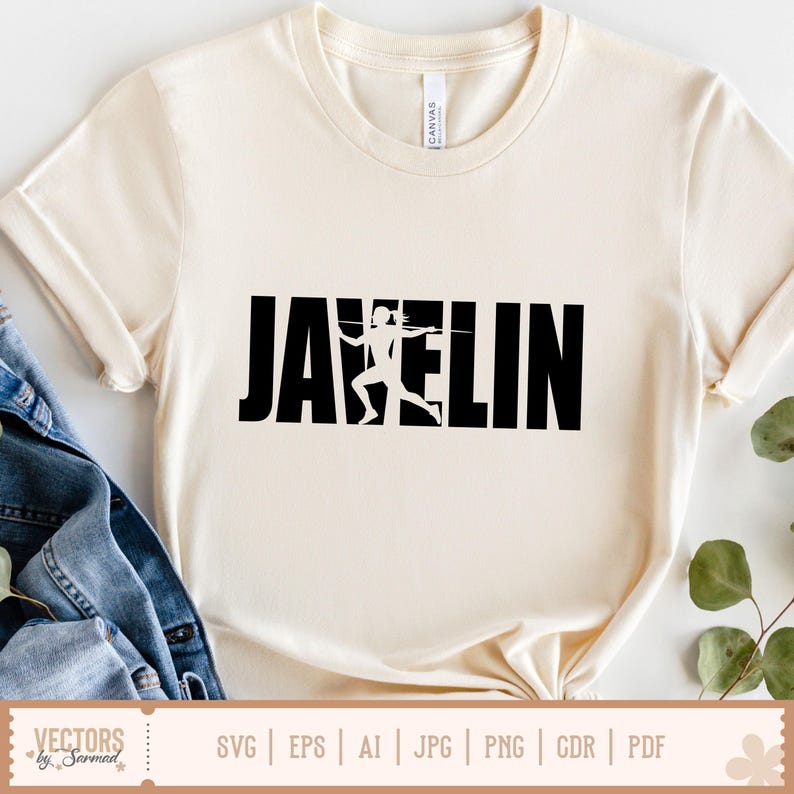Puede incluir: Camiseta color crema con la palabra "JAVELIN" en letras negras y audaces. Una silueta blanca de un lanzador de jabalina est&aacute; integrada en el dise&ntilde;o. La camiseta tiene cuello redondo y mangas cortas.