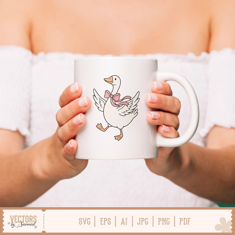 May include: A white ceramic mug featuring a graphic illustration of a white goose with orange feet and beak, wearing a light pink ribbon bow around its neck. The goose is depicted with its wings spread out as if walking or dancing on the mug surface.