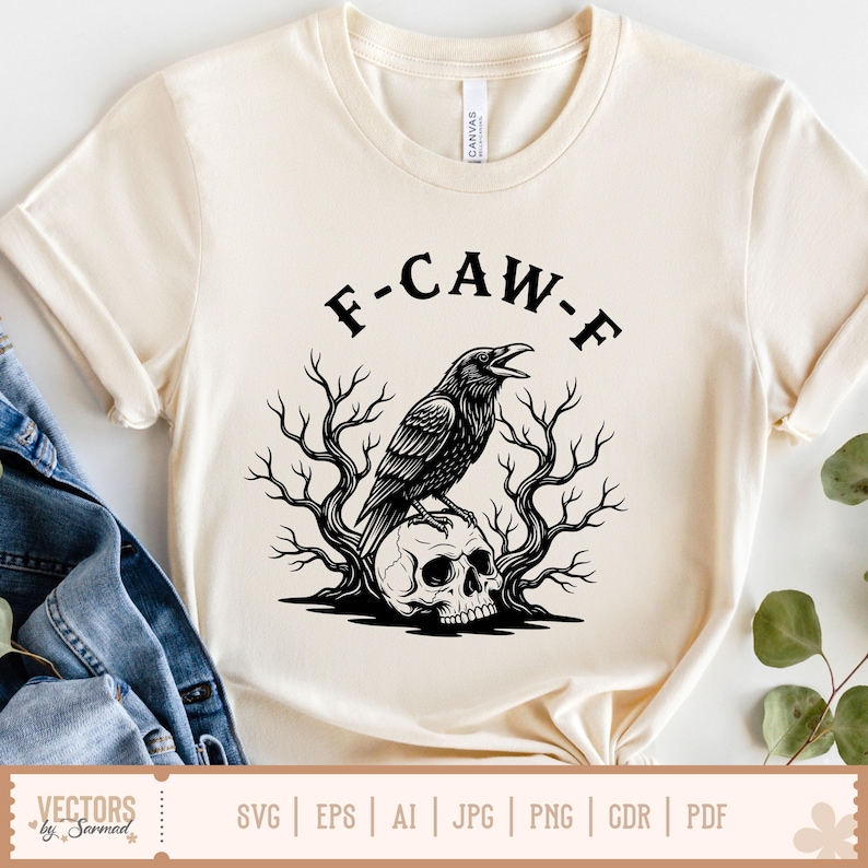 May include: Cream-colored t-shirt with the text "F-CAW-F" above a black illustration of a crow perched on a skull, surrounded by bare tree branches. The shirt has short sleeves and a round neckline. The bottom of the shirt shows file type icons.