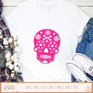 May include: A white t-shirt with a bright pink sugar skull graphic. The skull design includes floral and crossbones details. The shirt is styled with blue jeans and white trainers, creating a casual look. The image also includes text: "VECTORS by Sarmad".